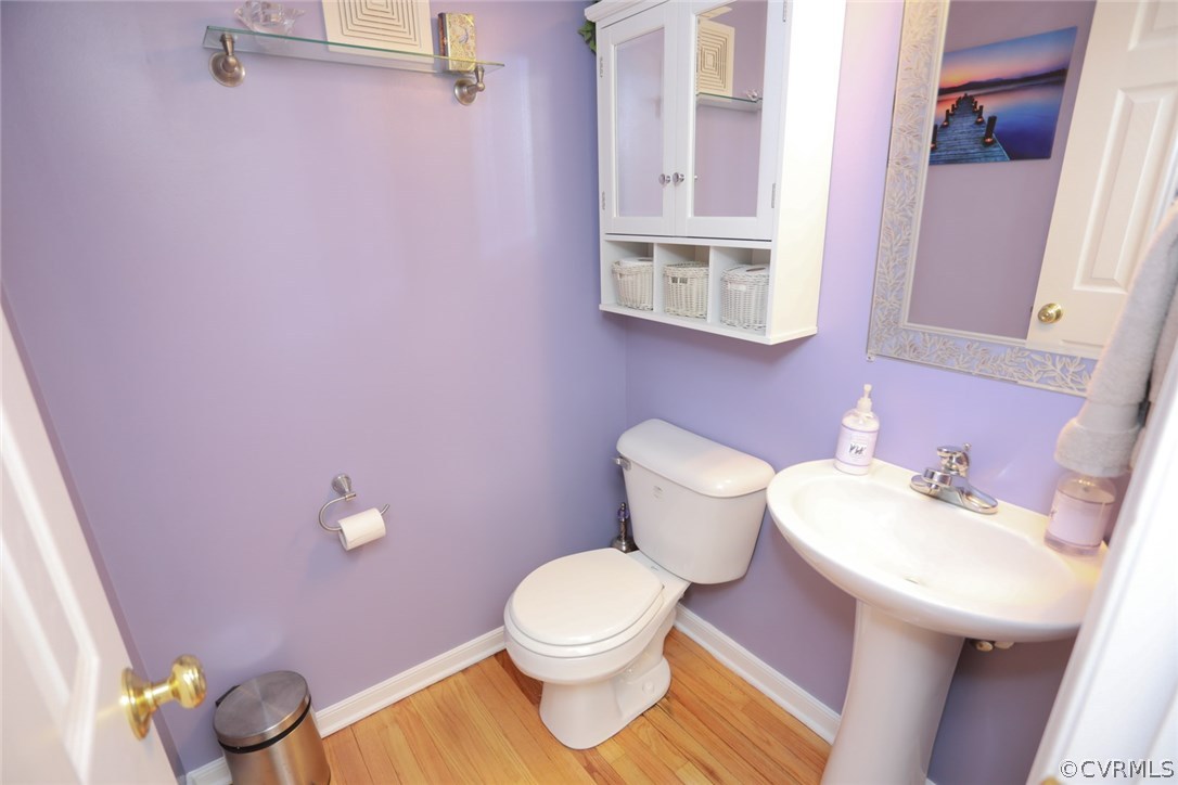 3830 Cabin Road Gum Spring, VA 23065 - Photo 16 of 32 a bathroom with a sink a toilet and a mirror