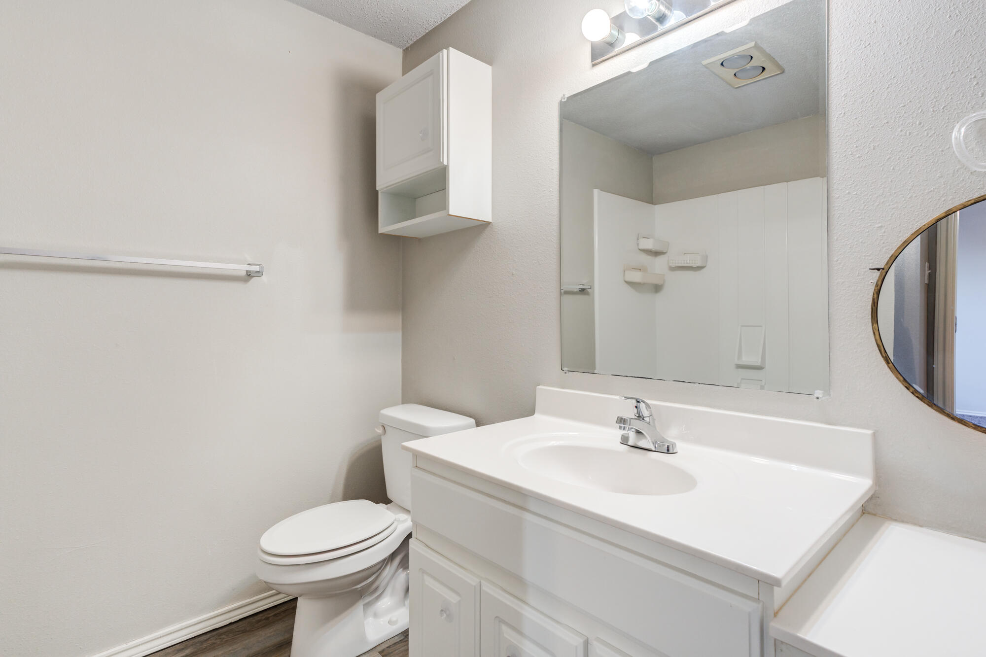 3425 97th Street Lubbock, TX 79423 - Photo 11 of 22 a bathroom with a sink toilet and a mirror