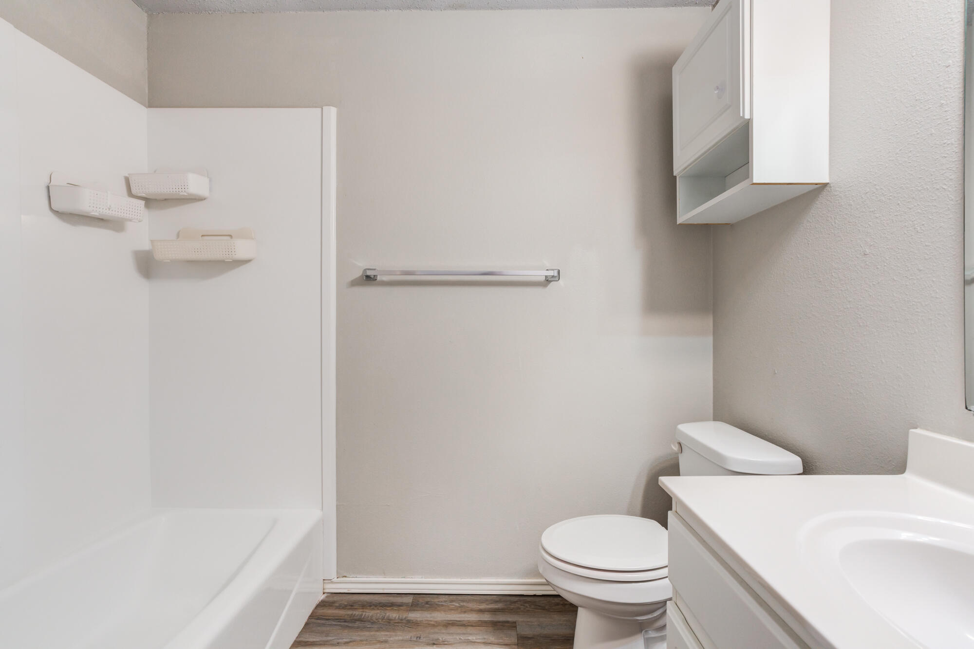 3425 97th Street Lubbock, TX 79423 - Photo 12 of 22 a white toilet sitting next to a bathroom sink