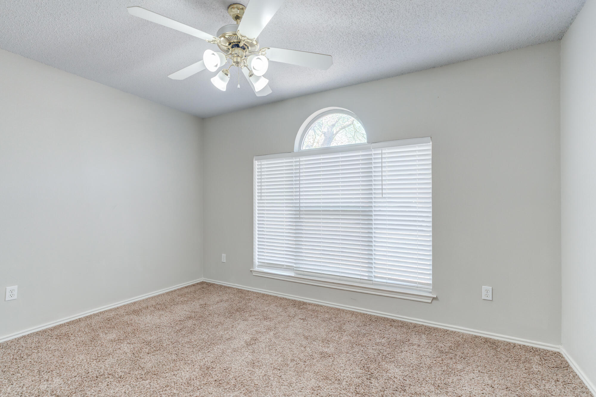 3425 97th Street Lubbock, TX 79423 - Photo 15 of 22 an empty room with windows and ceiling fan