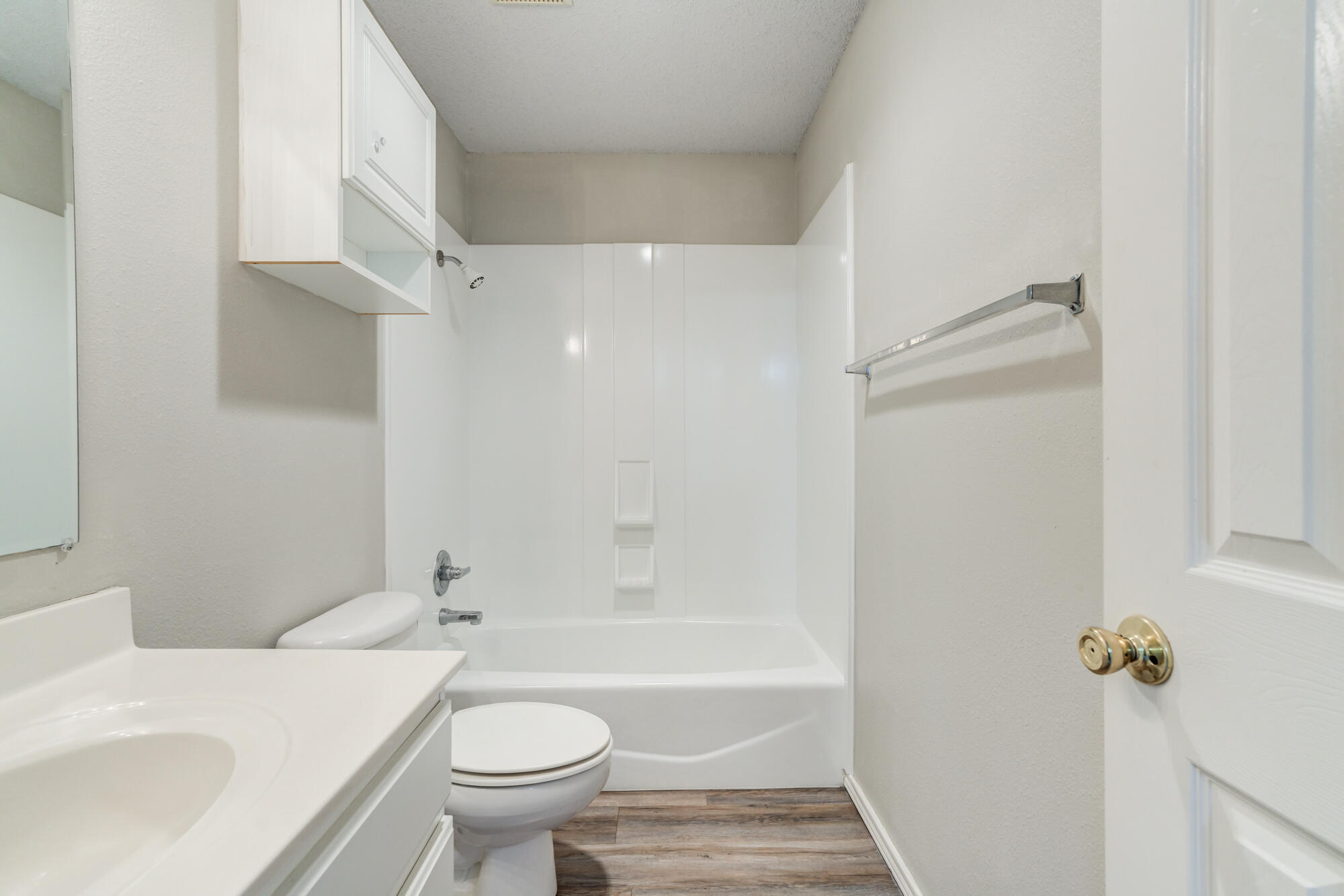 3425 97th Street Lubbock, TX 79423 - Photo 17 of 22 a bathroom with a sink a toilet and a bathtub