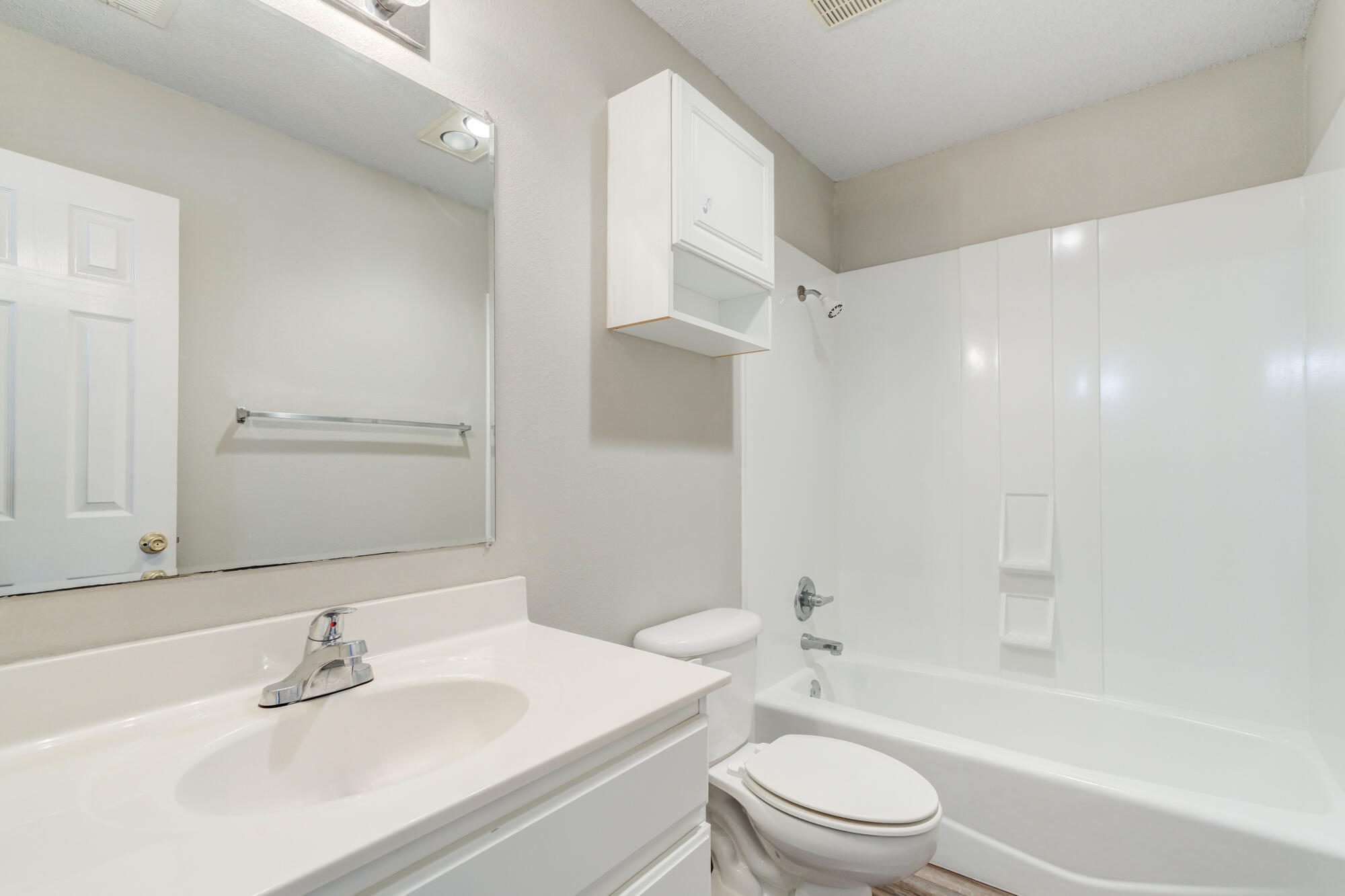 3425 97th Street Lubbock, TX 79423 - Photo 18 of 22 a bathroom with a bathtub shower sink vanity mirror and toilet