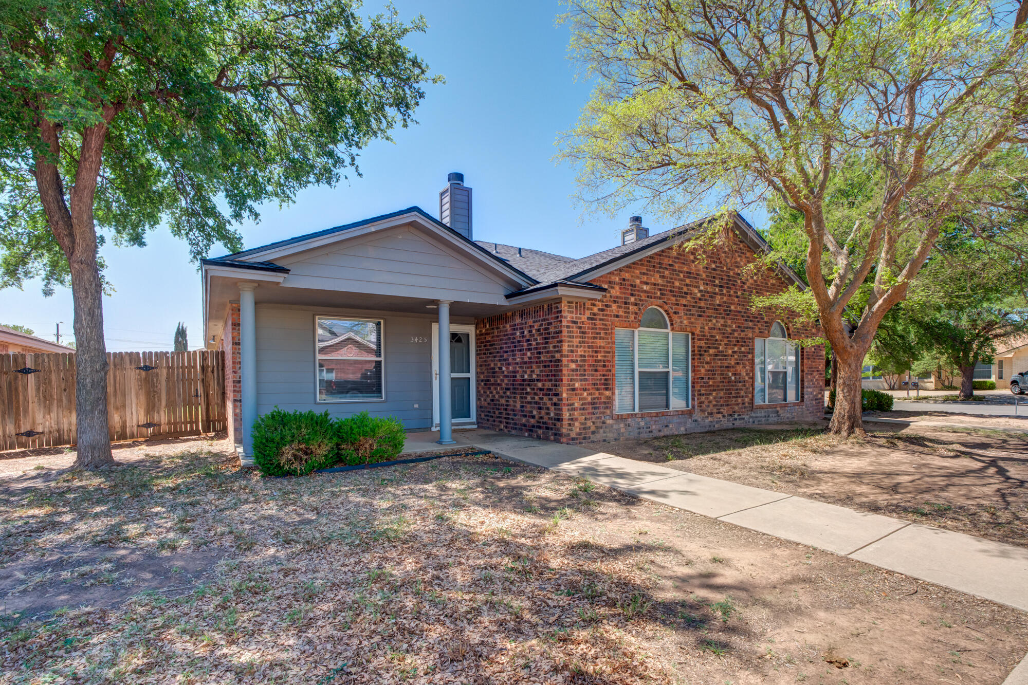 3425 97th Street Lubbock, TX 79423 - Photo 22 of 22 a front view of a house with a garden and trees