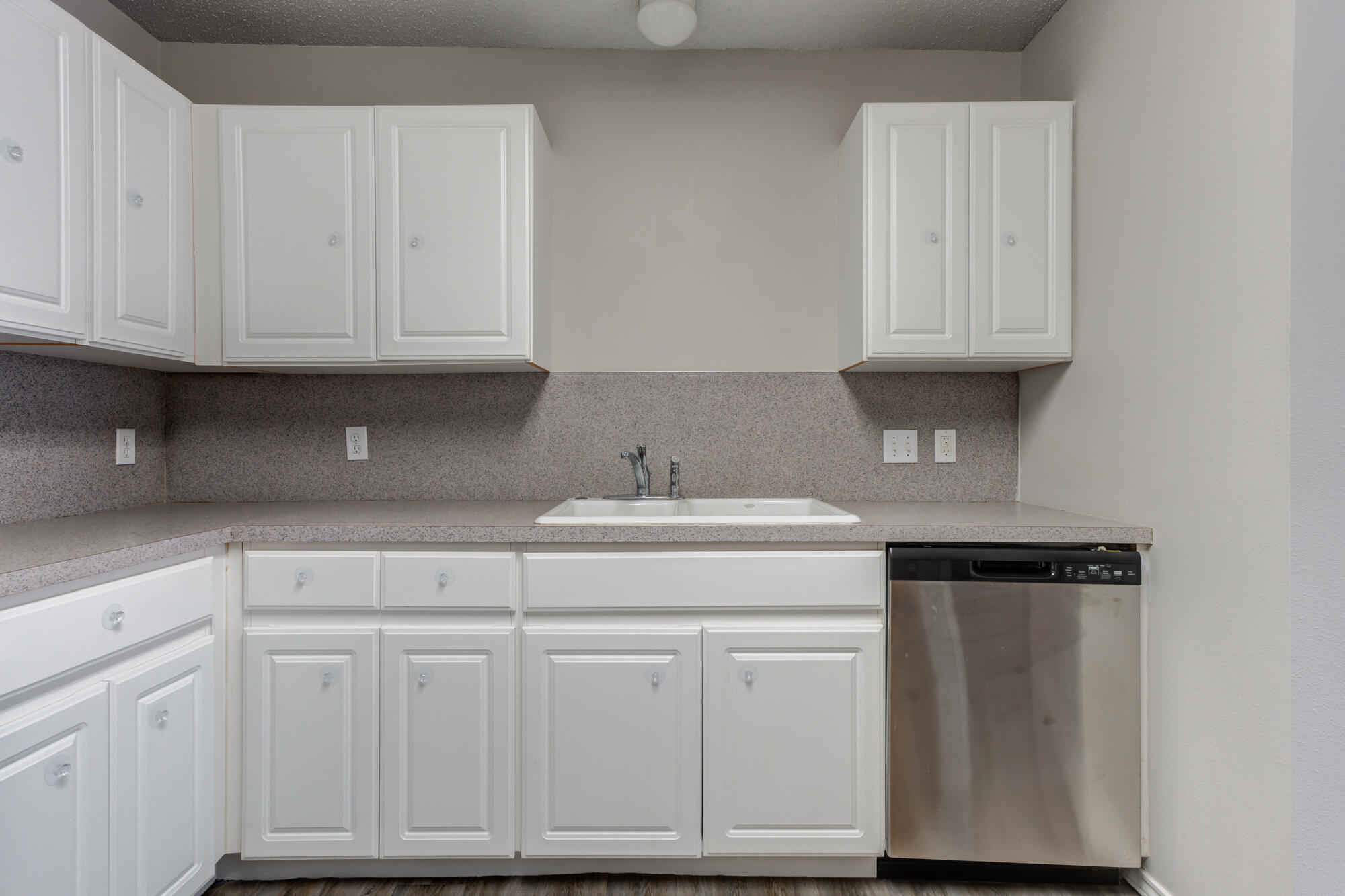 3425 97th Street Lubbock, TX 79423 - Photo 6 of 22 a kitchen with white cabinets
