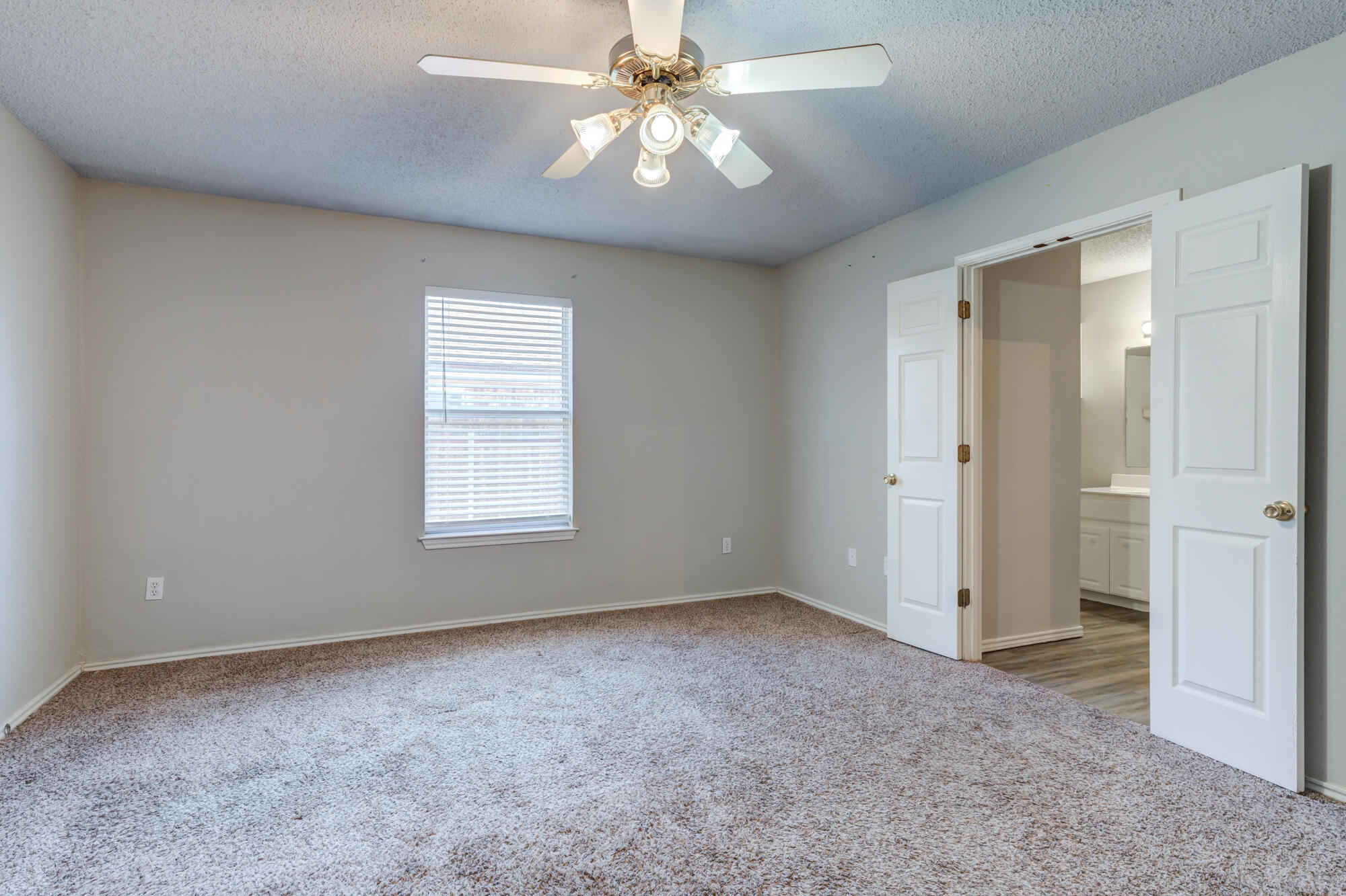 3425 97th Street Lubbock, TX 79423 - Photo 7 of 22 an empty room with windows and fan