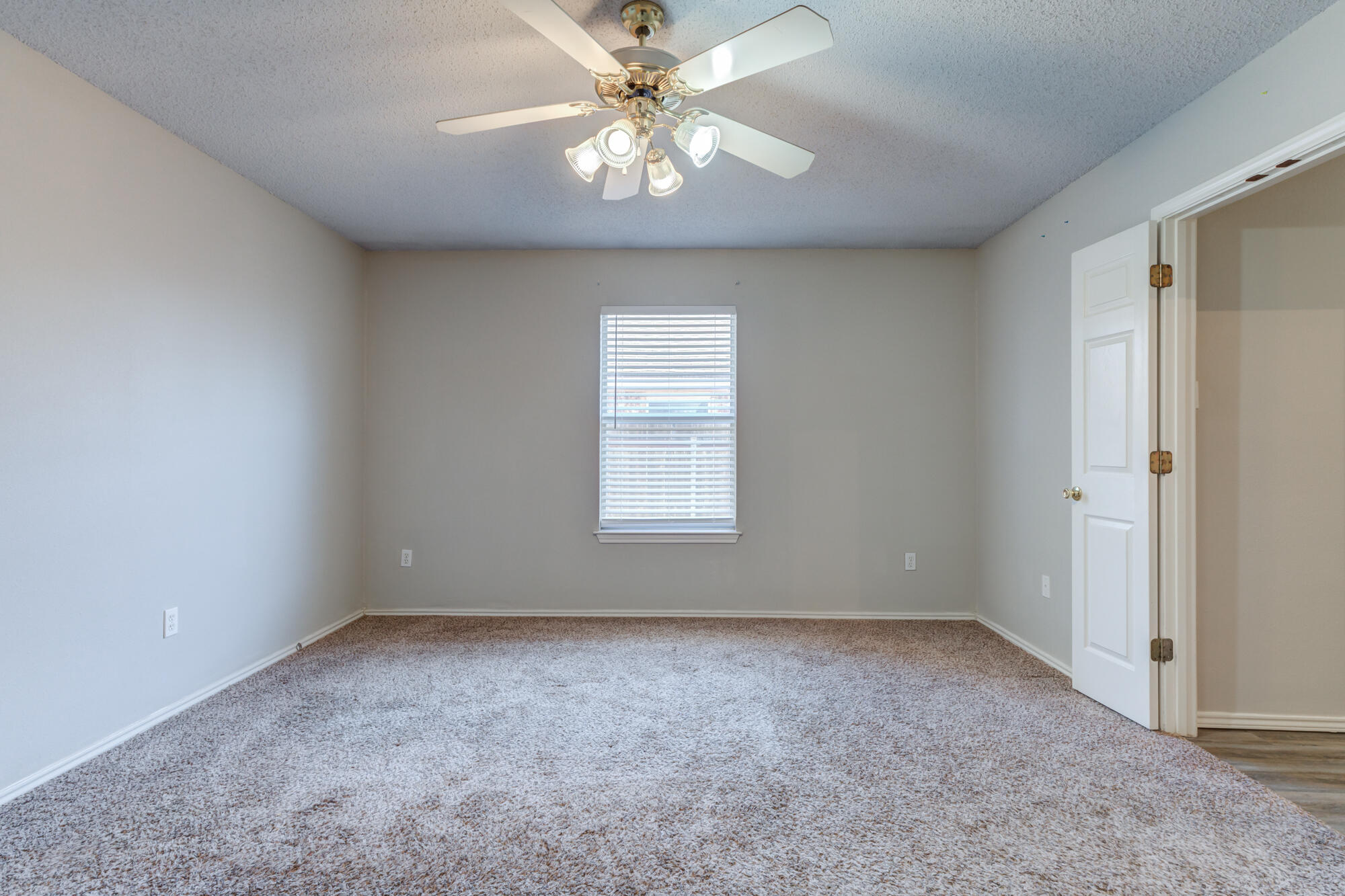 3425 97th Street Lubbock, TX 79423 - Photo 8 of 22 a view of room with window and ceiling fan