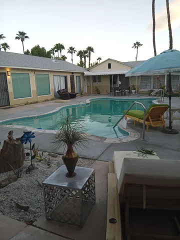 a view of a house with backyard porch and sitting area