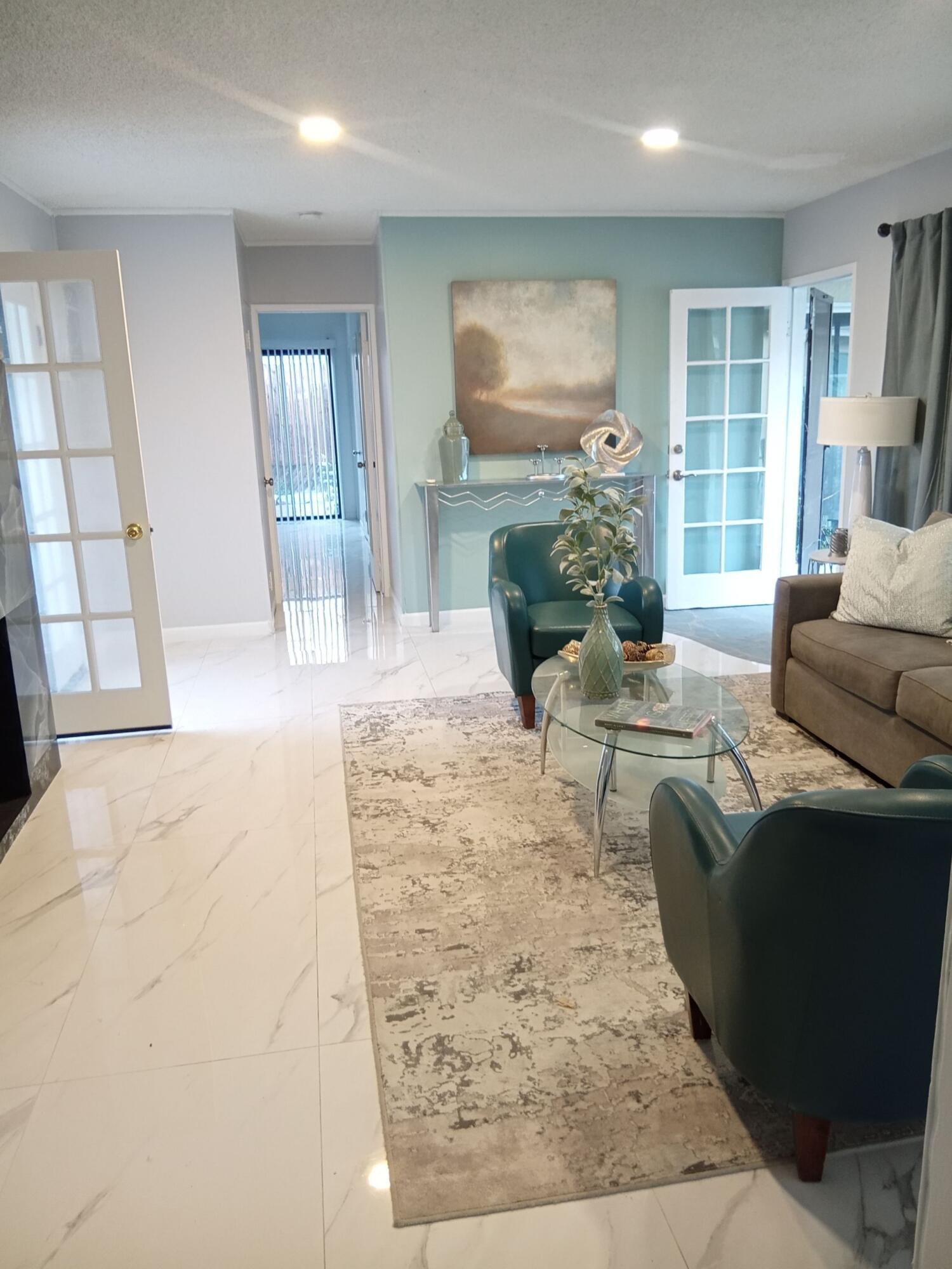 315 East Stevens Road, Unit 4 Palm Springs, CA 92262 - Photo 2 of 12 a living room with furniture and a flat screen tv