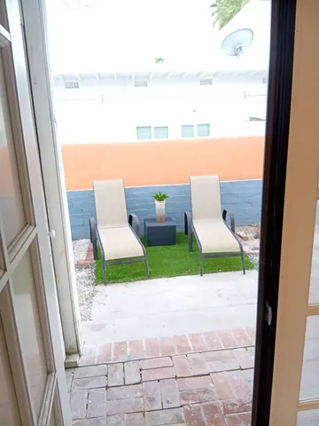 a view of a house with backyard and sitting area
