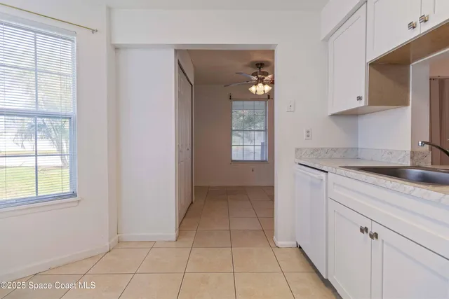 a kitchen with a sink a window and cabinets
