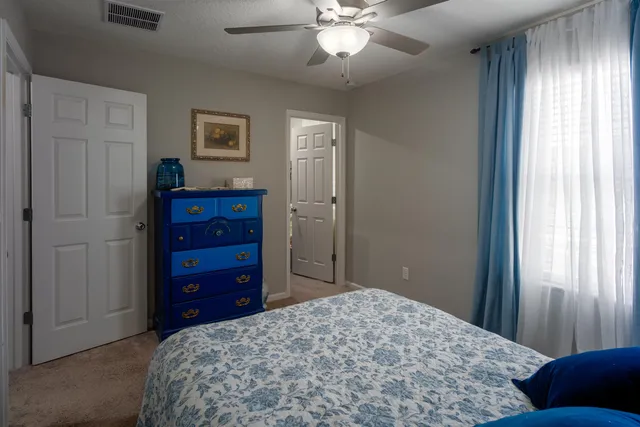 a bathroom with a granite countertop toilet and a sink