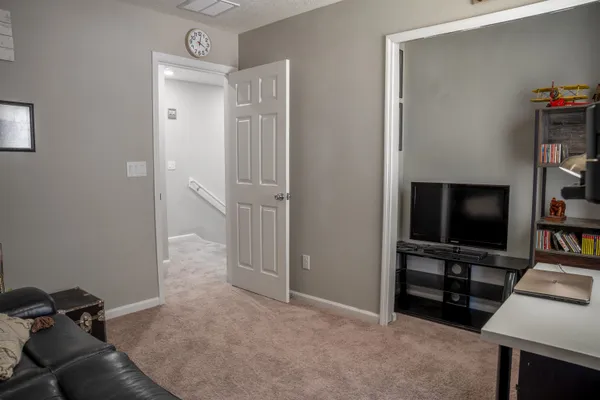 a view of living room with flat screen tv and dresser