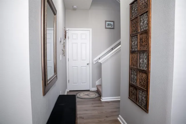 a view of a hallway with wooden floor