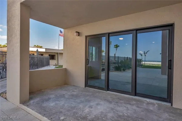 a view of a porch with a floor to ceiling window next to a building
