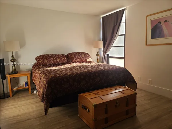 a bedroom with a bed and flat screen tv