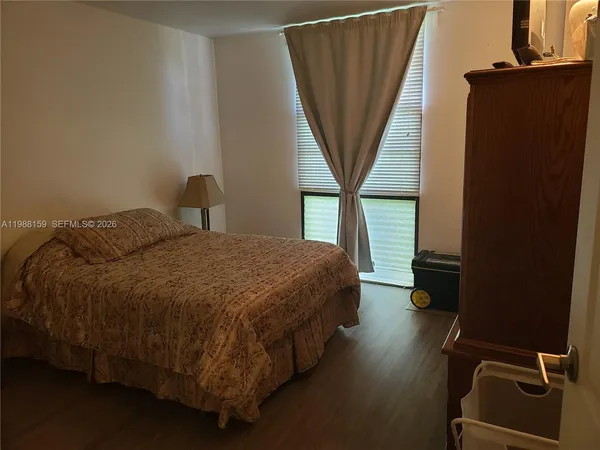 a bedroom with a bed and a mirror