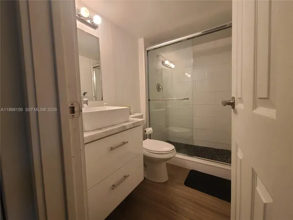 a kitchen with a sink a refrigerator and cabinets