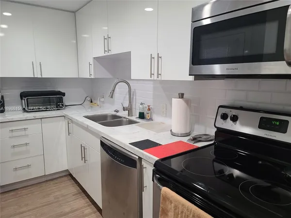 a kitchen with cabinets and stainless steel appliances