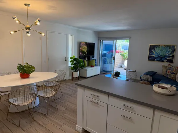 a kitchen with a table and a potted plant