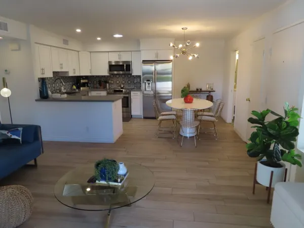 a kitchen with a refrigerator and a potted plant