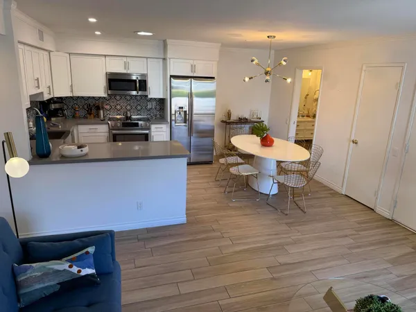 a large kitchen with stainless steel appliances kitchen island granite countertop a stove a sink and a refrigerator