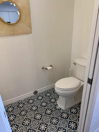 a bathroom with a toilet and a mirror