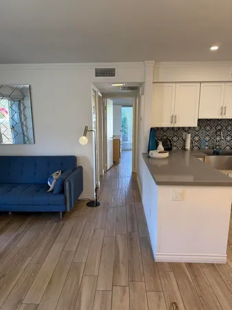 a kitchen with wooden floors and sink