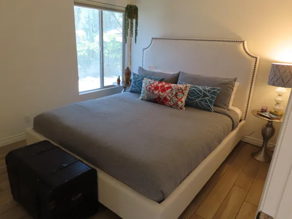 a bed sitting in a bedroom next to a window