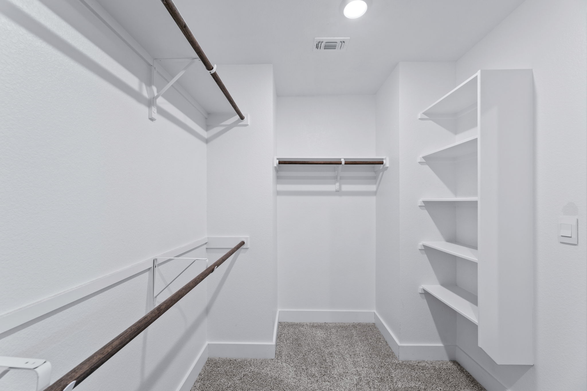 7312 Travertine Spring Drive Austin, TX 78744 - Photo 21 of 32 An organized closet offers ample space for storage with built-in shelving and hanging rods.