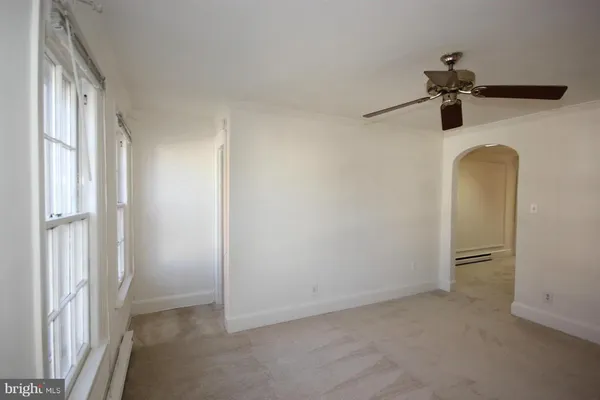 a view of empty room with ceiling fan