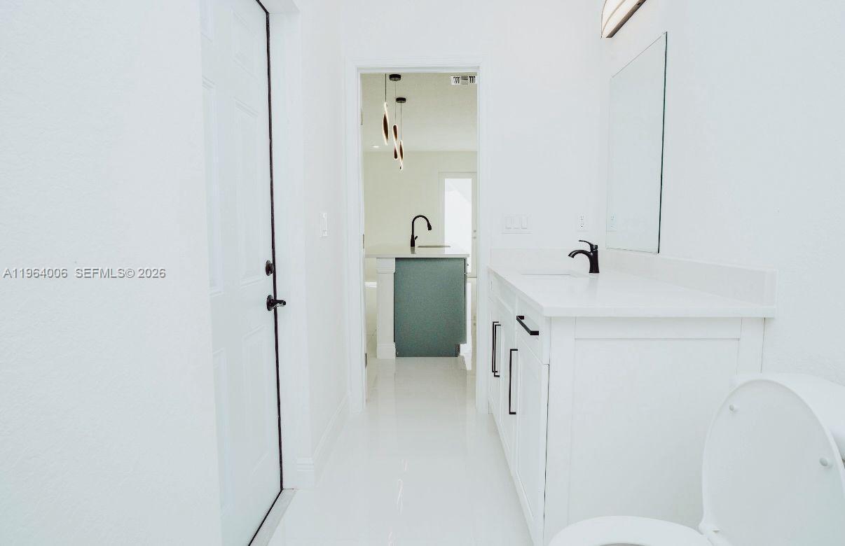 4405 East 7th Street Lehigh Acres, FL 33972 - Photo 3 of 6 a en suite bathroom with a granite countertop sink