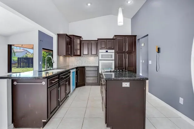 a kitchen with stainless steel appliances granite countertop a stove and refrigerator