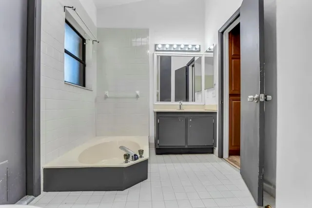 a bathroom with bathtub and shower