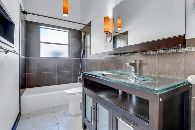 a bathroom with a sink a granite counter top and a mirror