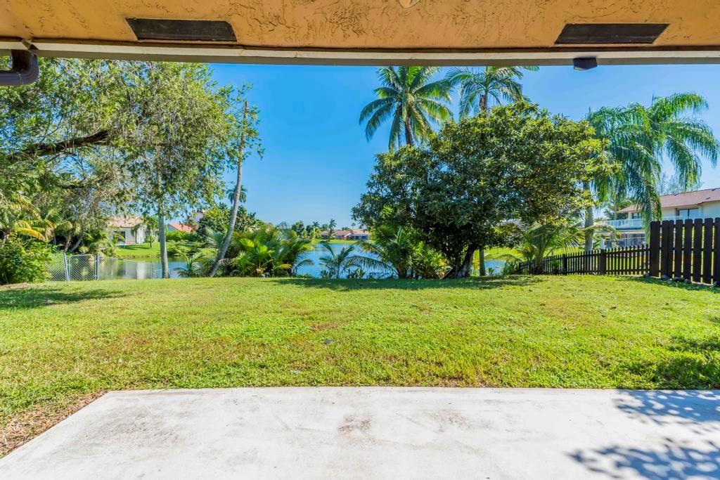 5720 West Waterford Drive Davie, FL 33331 - Photo 10 of 25 a view of a backyard with plants and palm trees