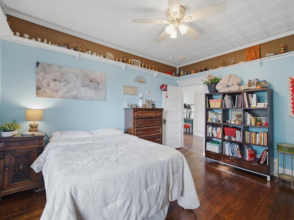 907 4th Street Graham, TX 76450 - Photo 20 of 34 a bedroom with a bed and a book shelf