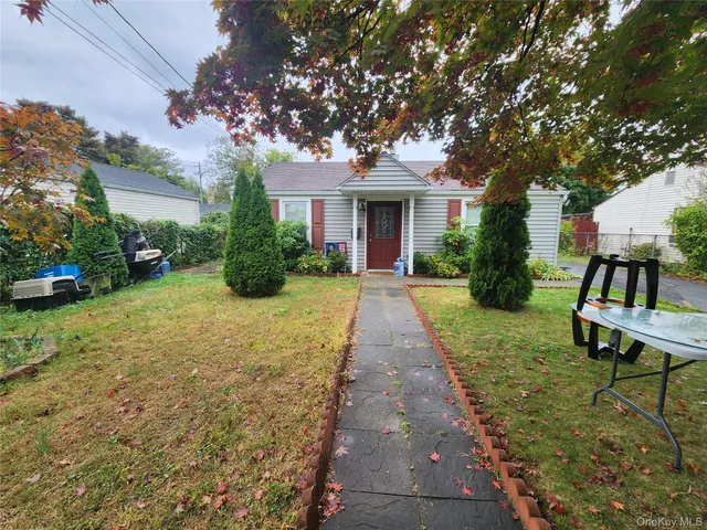 a front view of a house with yard and green space