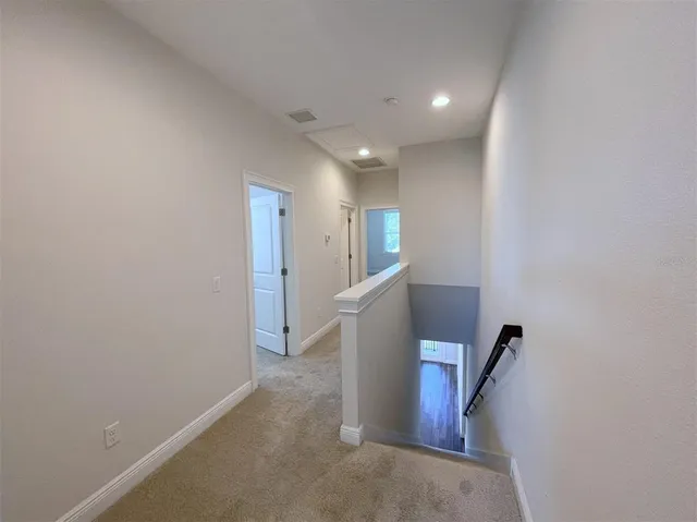 a view of a hallway with staircase