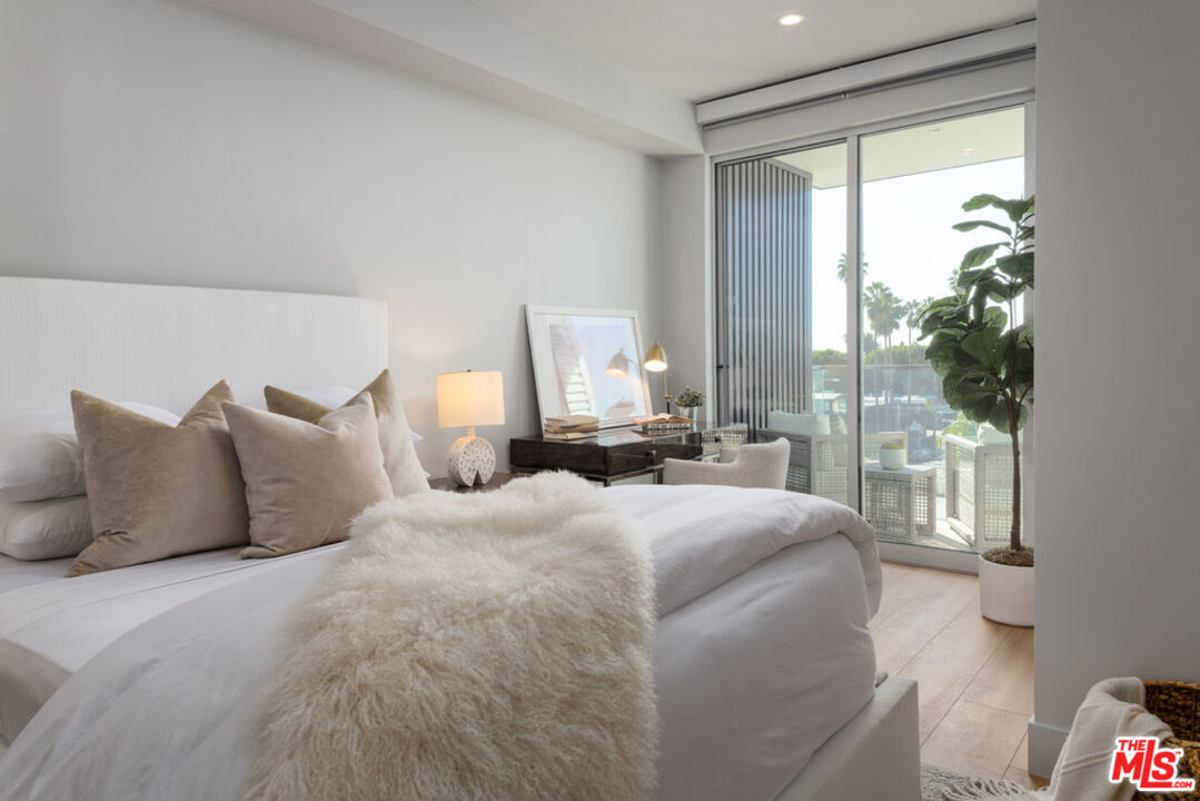 12431 Rochester Avenue, Unit PH4 Los Angeles, CA 90025 - Photo 9 of 28 a bedroom with bed and a large window