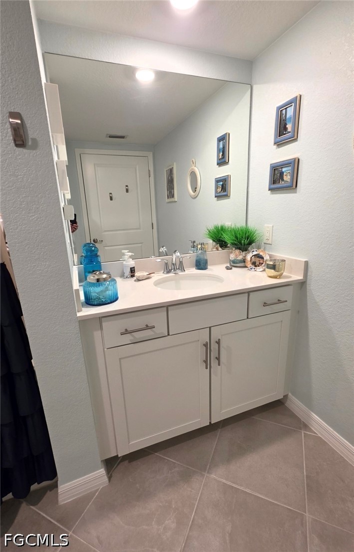 14191 Poppy Fld Loop, Unit 5312 Punta Gorda, FL 33955 - Photo 33 of 41 a bathroom with a sink mirror and vanity