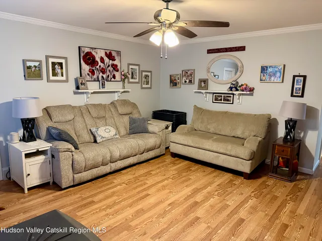 a living room with furniture and a chandelier
