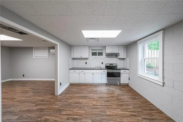 a large kitchen with stainless steel appliances granite countertop a stove and a refrigerator