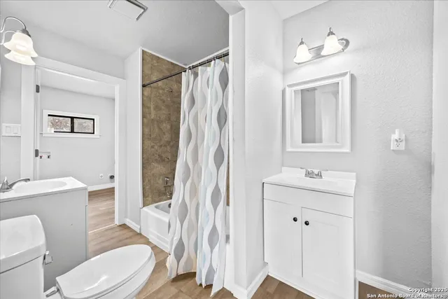 a white toilet sitting next to a bathroom sink