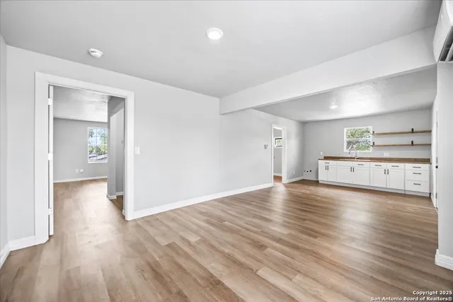 a view of a room with wooden floor and windows
