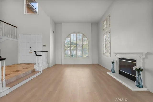wooden floor in an empty room with a fireplace