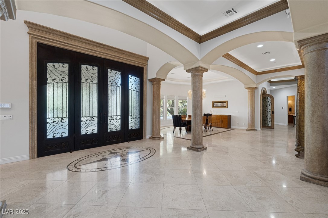 1545 Villa Rica Drive Henderson, NV 89052 - Photo 13 of 61 Foyer with french doors, decorative columns, crown molding, arched walkways, and recessed lighting