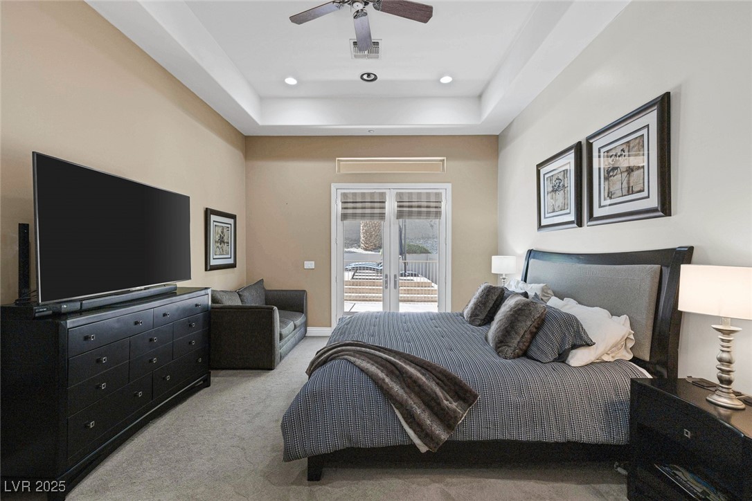 1545 Villa Rica Drive Henderson, NV 89052 - Photo 29 of 61 Bedroom with access to outside, light colored carpet, a tray ceiling, recessed lighting, and a ceiling fan