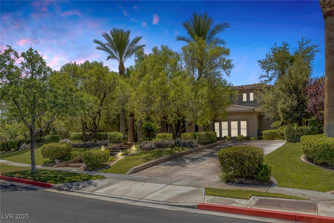 1545 Villa Rica Drive Henderson, NV 89052 - Photo 3 of 61 View of front facade with decorative driveway, a lawn, stucco siding, a tiled roof, and french doors