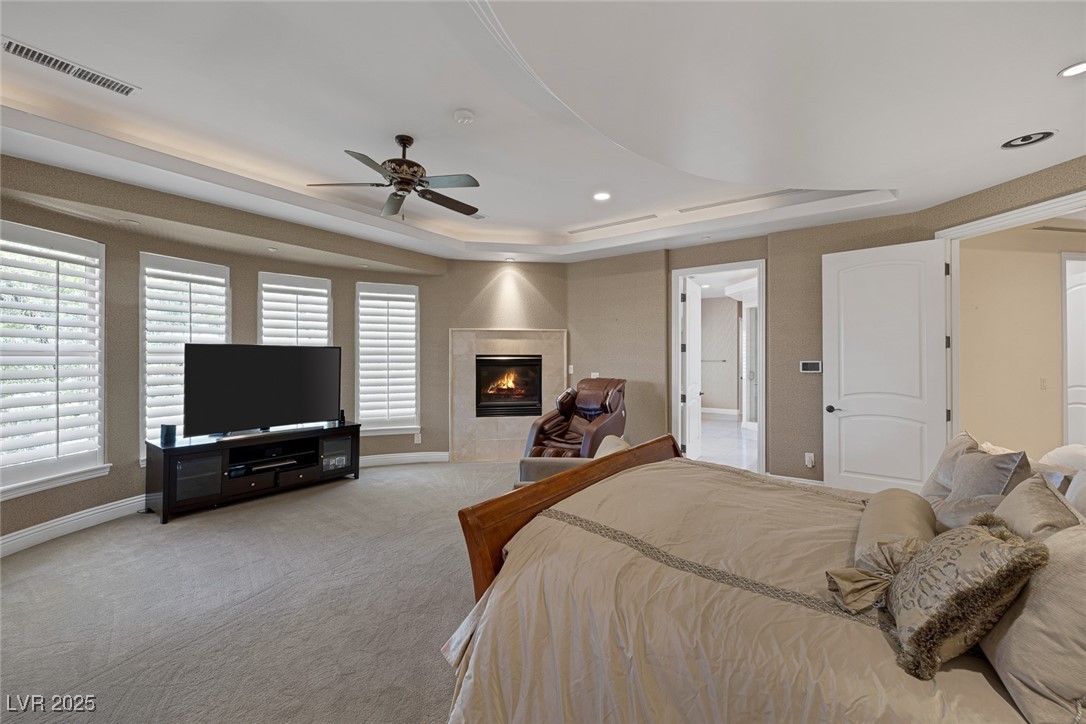 1545 Villa Rica Drive Henderson, NV 89052 - Photo 32 of 61 Bedroom with recessed lighting, carpet, a tiled fireplace, and a tray ceiling