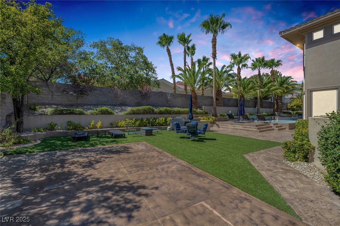 1545 Villa Rica Drive Henderson, NV 89052 - Photo 37 of 61 Yard at dusk featuring a fenced backyard and a patio